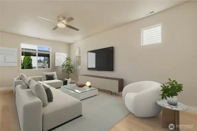 This inviting living room offers a spacious, comfortable setting perfect for relaxation or entertaining. The open layout easily accommodates large furniture, and the oversized windows fill the space with natural light.