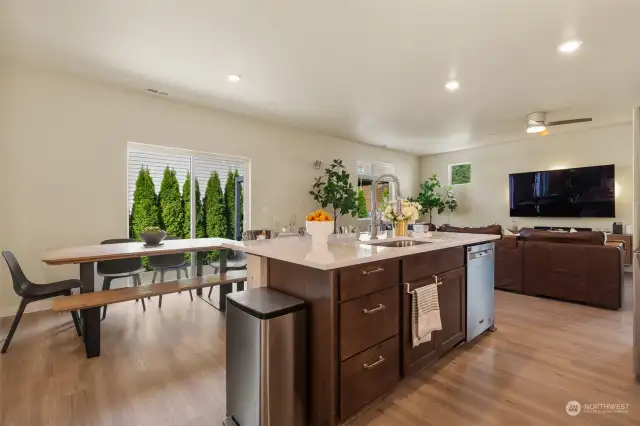 The kitchen is anchored by a generous island with a gleaming countertop, perfect for meal prep or casual dining. With the separate sink in the island two cooks can easily work in the kitchen and save time prepping meals.