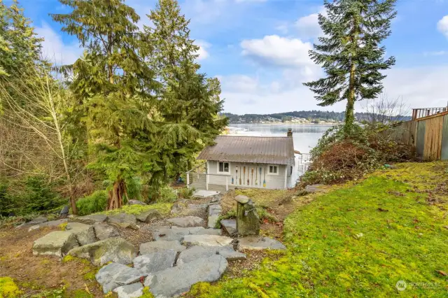 View of Main Cottage from above facing the water (north) Easy gravel trail or lawn and stone steps lead to the waterfront cottages