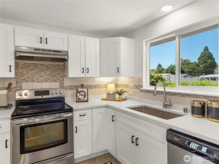 All new cabinets, countertops, kitchen sink, and hood vent. All appliances stay!