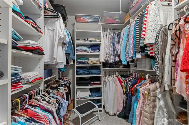 Primary room walk in closet with plenty of shelving