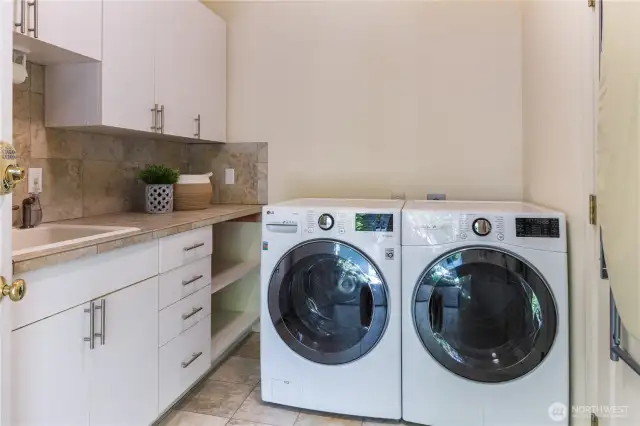 Laundry room w/ exterior door to courtyard that leads to detached garage.
