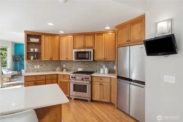 Nicely appointed kitchen w/ Wolf range, quartz counters & new fridge