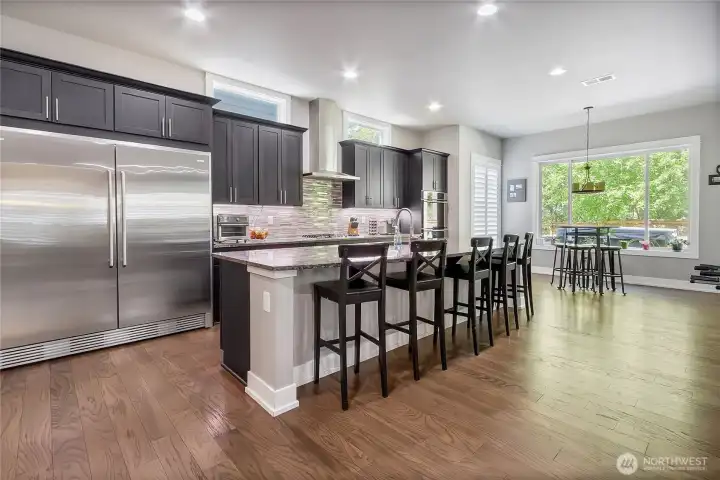 Chef's kitchen with large island and oversize refrigerator