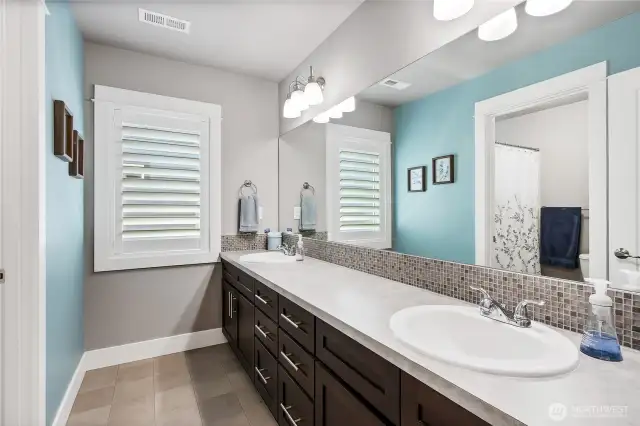 Full bathroom on upper level with double sinks
