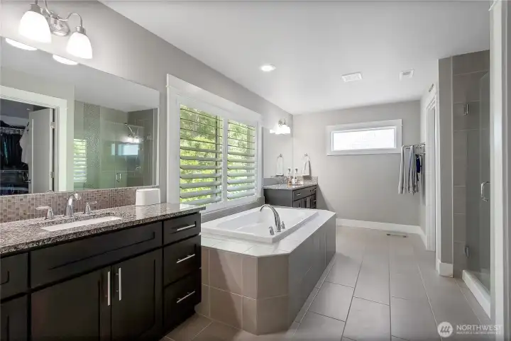 En suite attached to primary bedroom. Double vanities.
