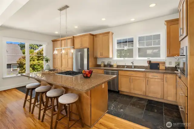 Open layout kitchen with plenty of cabinet storage and convenient breakfast bar