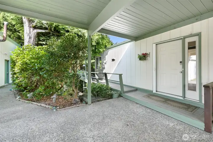 Covered entry. Deck wraps around to the back.