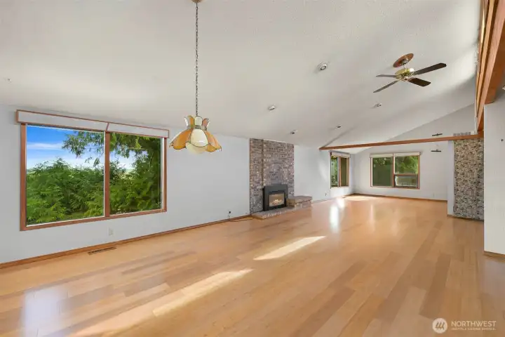 Dining area and living room space with gas fireplace.