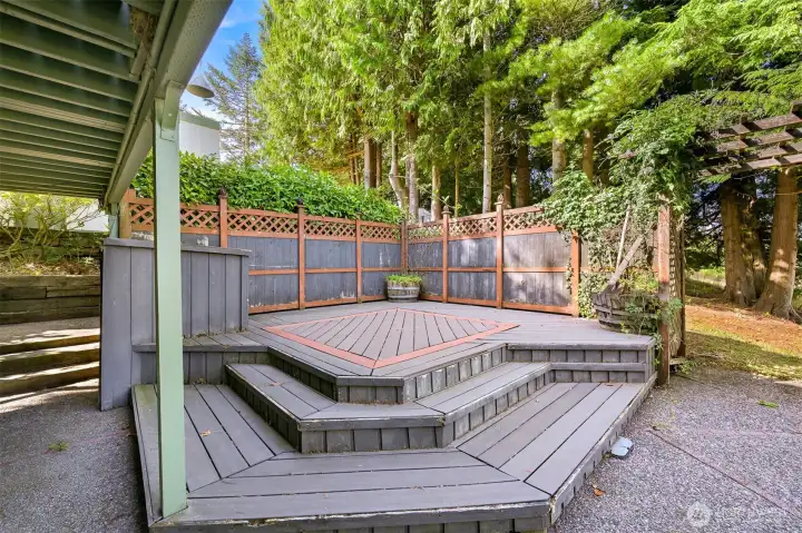 Private deck off of lower level patio. Potential hot tub area?