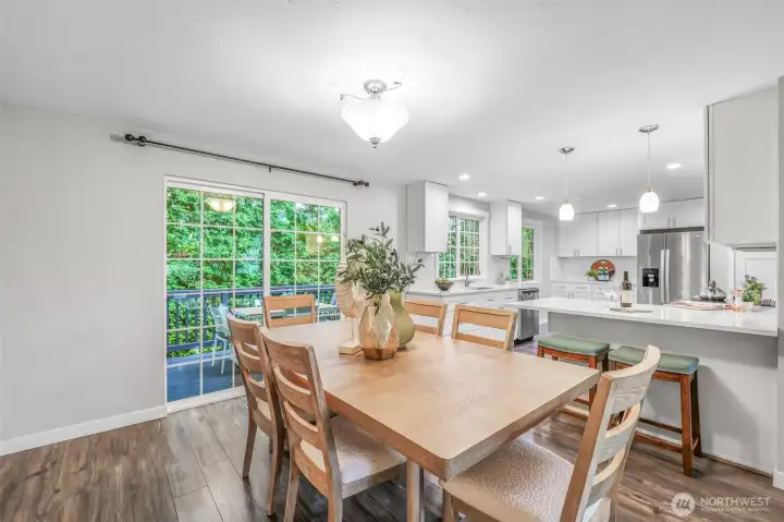 The dining area sits adjacent to the kitchen, offering easy access to the deck through large sliding glass doors. Natural light pours in, creating a comfortable space for daily meals or entertaining.