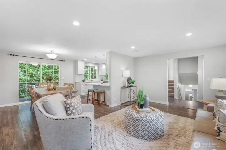 Looking back toward the kitchen and dining spaces, you can see how the living room integrates beautifully with the heart of the home. This connected design enhances both everyday living and entertaining.