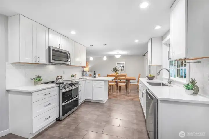From this angle, the kitchen showcases its thoughtful layout, with generous counter space and storage. Overlooking the dining area, it encourages connection while meals are being prepared.