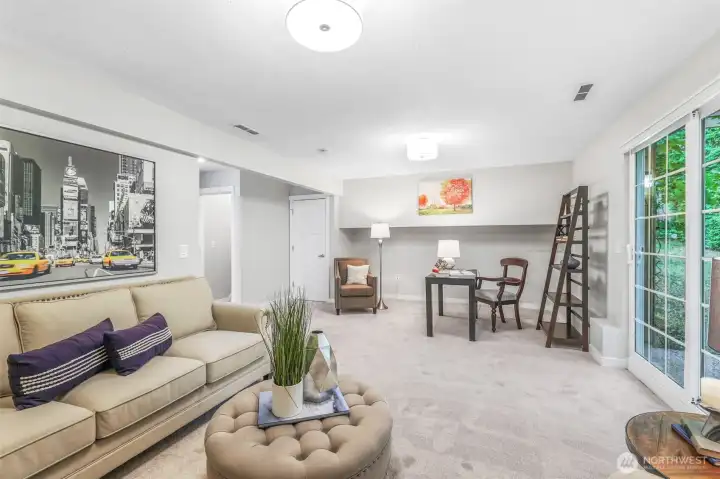 Another view of the family room emphasizes its open feel and natural light from sliding glass doors. This lower-level retreat offers a perfect place for both relaxation and play.