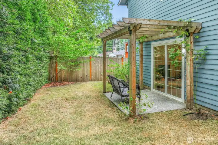 From this view, the pergola frames the patio space beautifully. Conveniently located off the lower level, it provides easy access to outdoor living.
