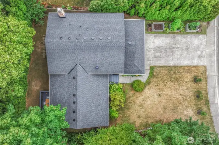 Aerial view of the property showcases the home’s generous lot, mature landscaping, and functional layout. The setting offers both privacy and convenience in the desirable Kingsgate neighborhood of Woodinville.
