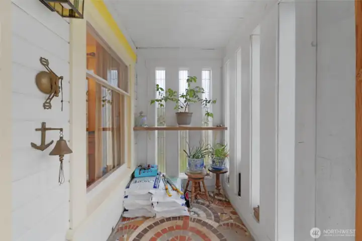 The enclosed front porch is a warm bright place for a morning coffee.