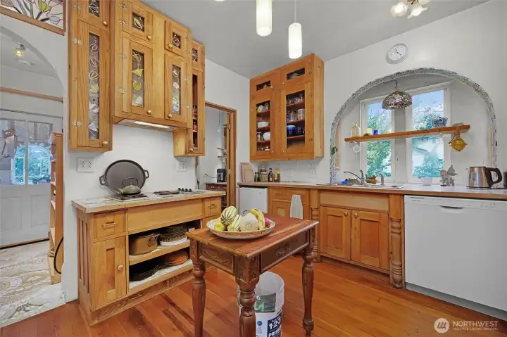 The kitchen has custom cabinets with stained glass.  A large butler's pantry is through the door on the far right.