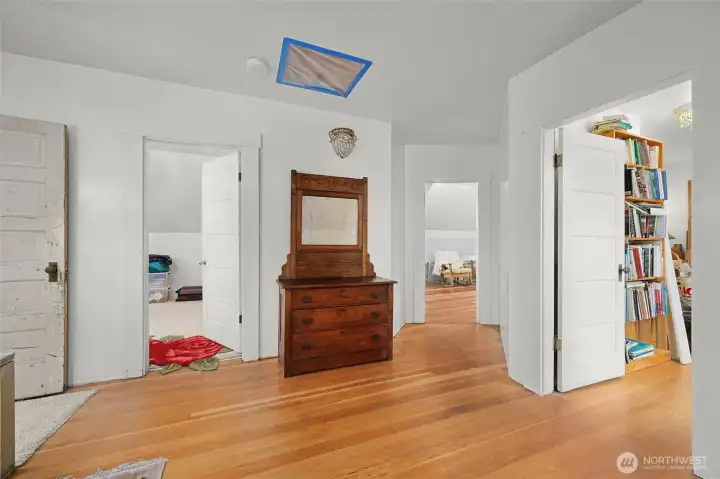 A view of the three upstairs bedrooms from the landing.  The upstairs bathroom is on the left. Drywall and paint have already been taken care of upstairs.