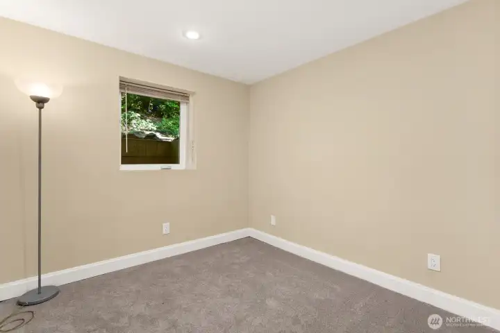Third bedroom features a casement window and recessed lighting.