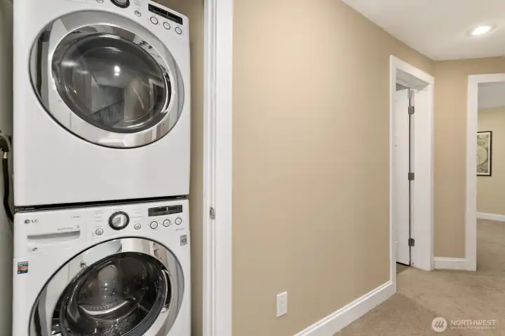 Tucked neatly into the lower-level hallway, the stacked LG washer and dryer offer modern convenience without sacrificing space.