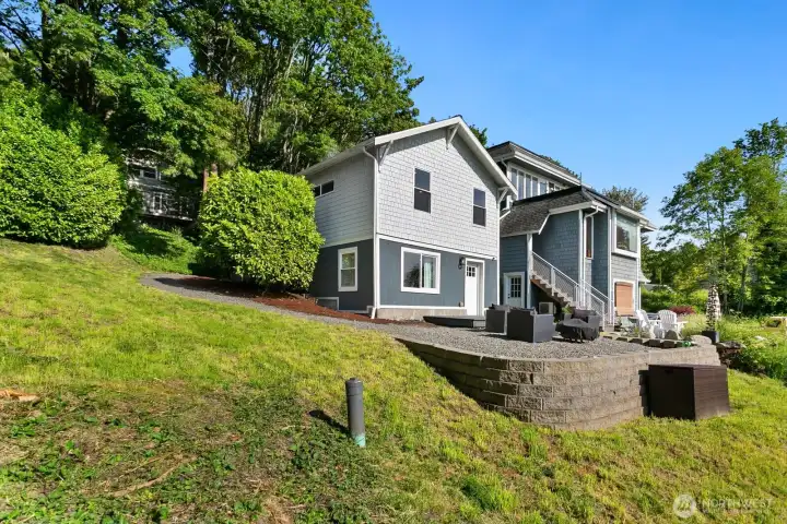 Nestled into a hillside, this thoughtfully designed home features a terraced yard, spacious patio for entertaining, and serene greenbelt surroundings for added privacy.