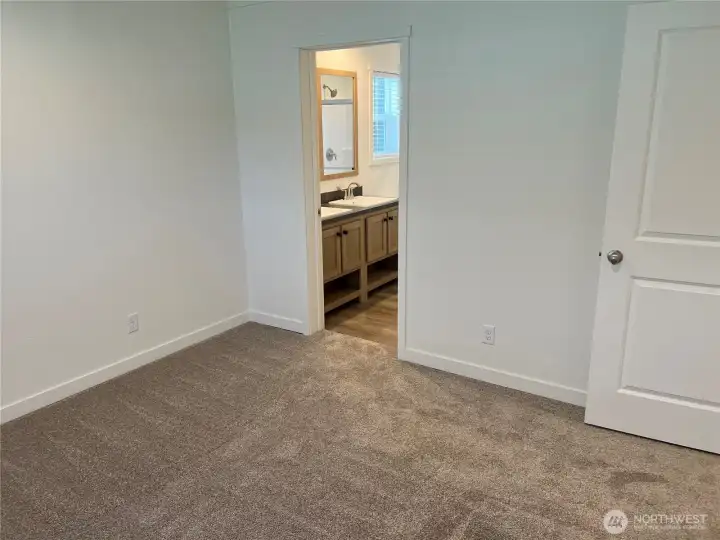Primary bedroom looking into the primary bathroom.