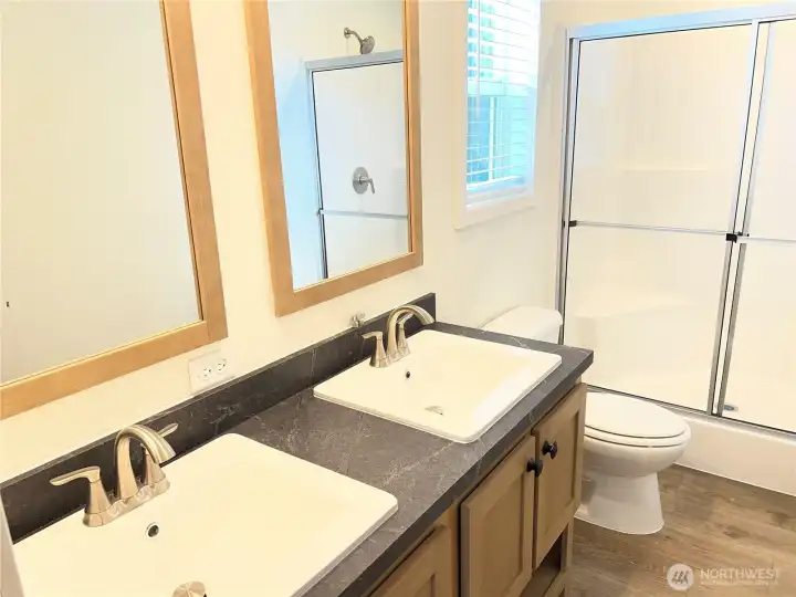 Primary bathroom with double vanities and walk in shower.