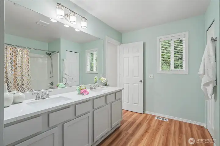 Updated flooring and quartz counters in the primary bath.