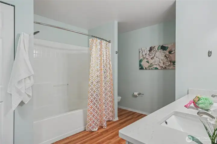 Primary bathroom suite with linen closet and a tub/shower surround.