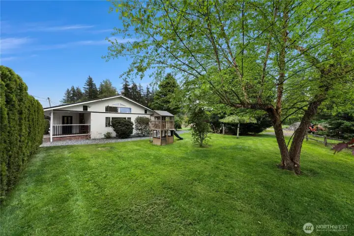 Front of house has additional privacy from driveway area, play structure and mature landscaping - mini oasis for your enjoyment!