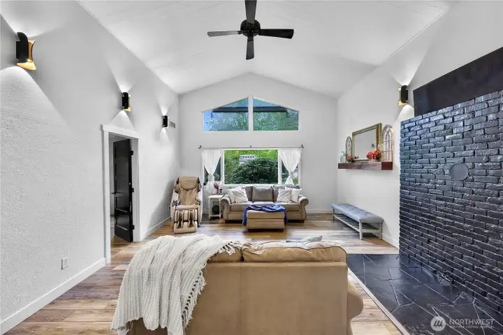 Large main living area with vaulted ceilings and windows looking out to your property, relaxing and functional - old gas fire place was removed but new could be reinstalled if you choose!