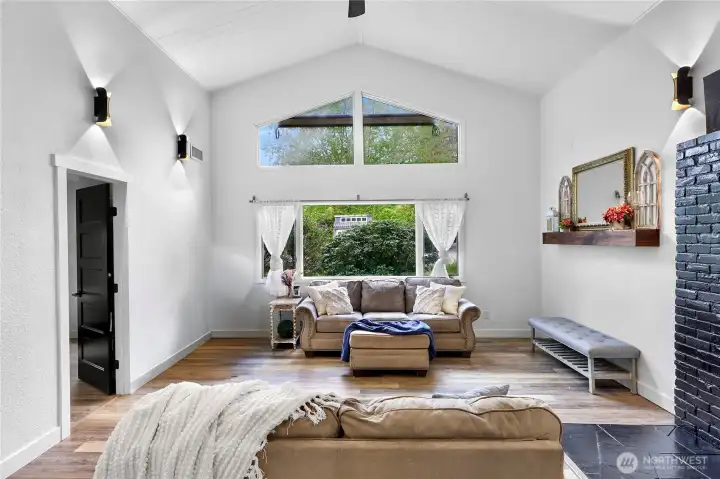 Large main living area with vaulted ceilings and windows looking out to your property, relaxing and functional - old gas fire place was removed but new could be reinstalled if you choose!