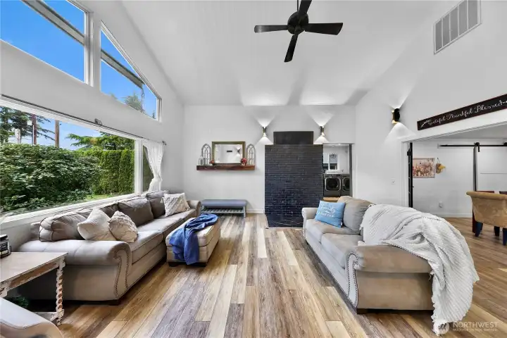 Living space filled with tons of natural light from the vaulted ceilings and large picture window