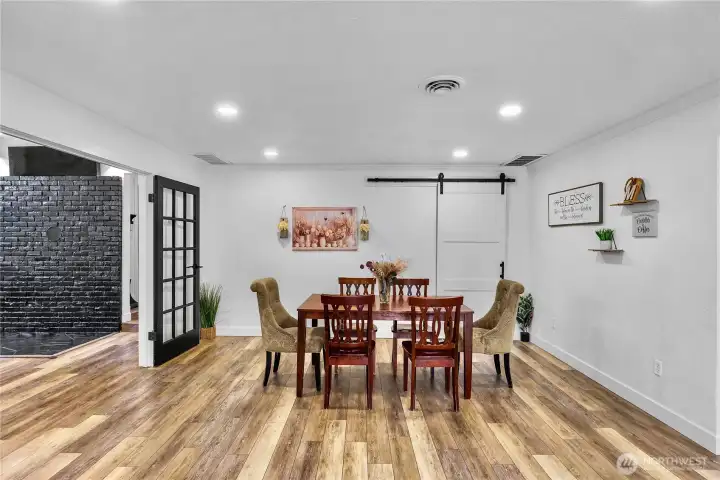 Large dining space easily fit and 8-10 person dining table - barn door is "accent piece" recent remodel updated the size of laundry/utility room behind and turned into a larger full primary bath