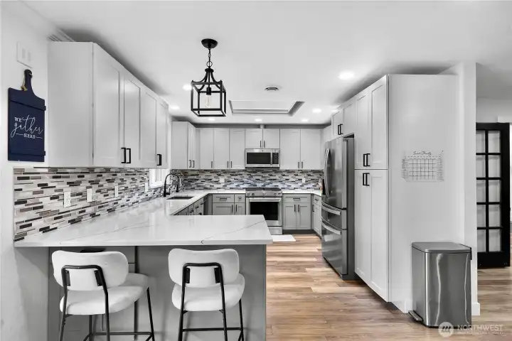 Fully remodeled kitchen with eating bar, soft close cabinets, stainless steel appliances and huge skylight with custom window covering to hold heat in for winter months and keep it out in the summer months - so energy efficient!