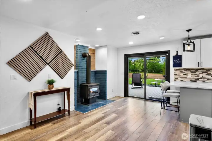 Open bright eating or relaxation nook located off kitchen, wood burning fire place makes this space just so cozy!