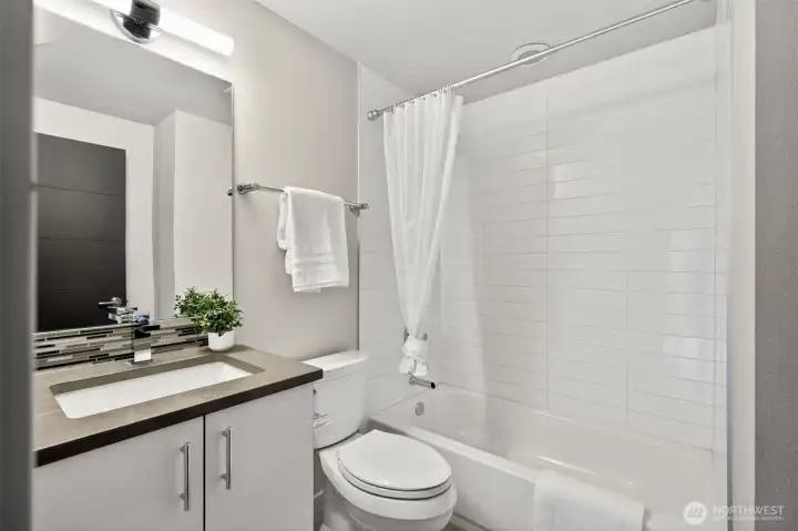 Full bath with tub and tile surround