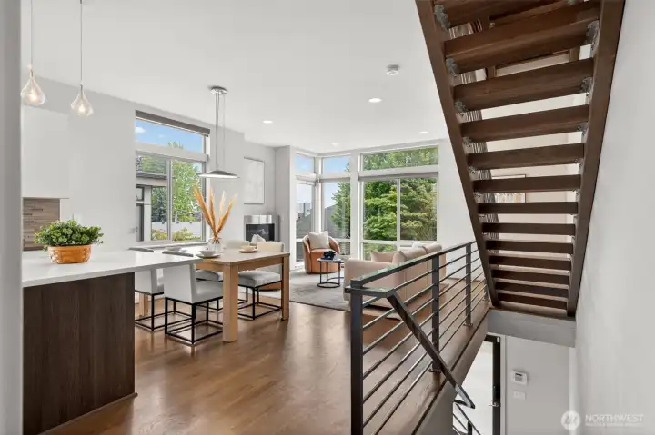 Open main level with hardwood floors and floating stair