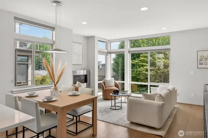 Dining area with large windows and treetop views