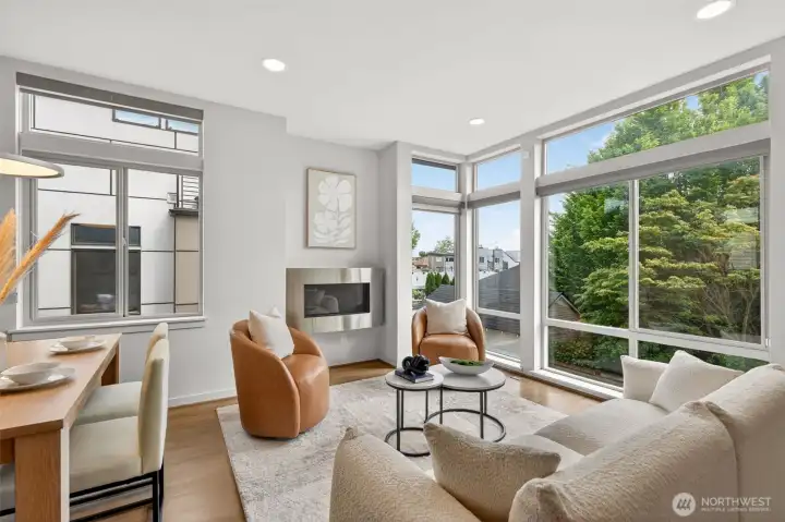 Living room with floor to ceiling corner windows and treetop views
