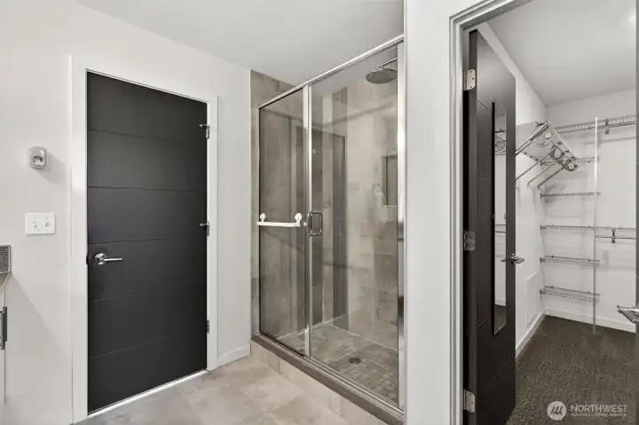 Primary bath with frameless glass shower and tile surround
