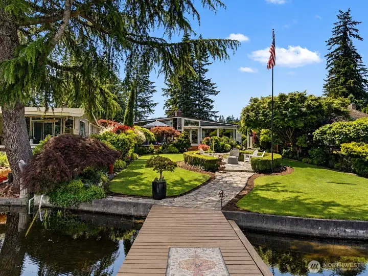 A truly rare Lake Sawyer retreat, where award-winning landscaping, manicured grounds, and peaceful waterfront living come together in perfect harmony. Follow the dock to a private outdoor sanctuary designed for relaxation, entertaining, and enjoying the beauty of every season.