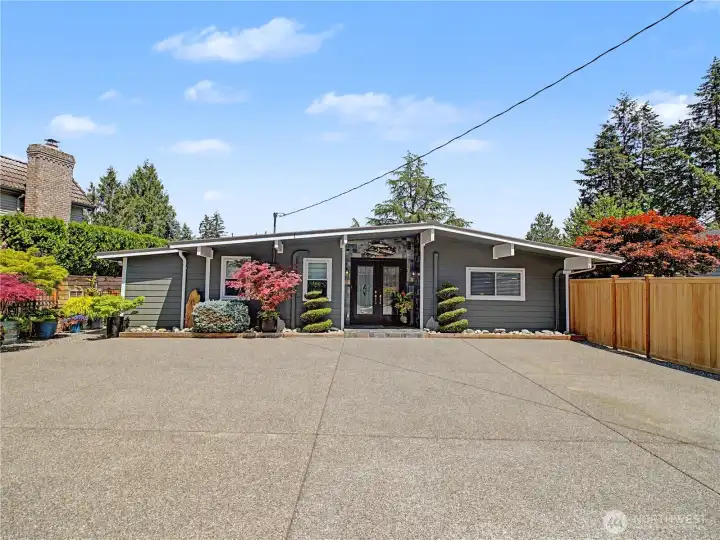 This stunning rambler makes an unforgettable first impression with its custom front entrance, manicured gardens, and timeless architectural design. Thoughtful updates and meticulous maintenance create a truly turnkey property.