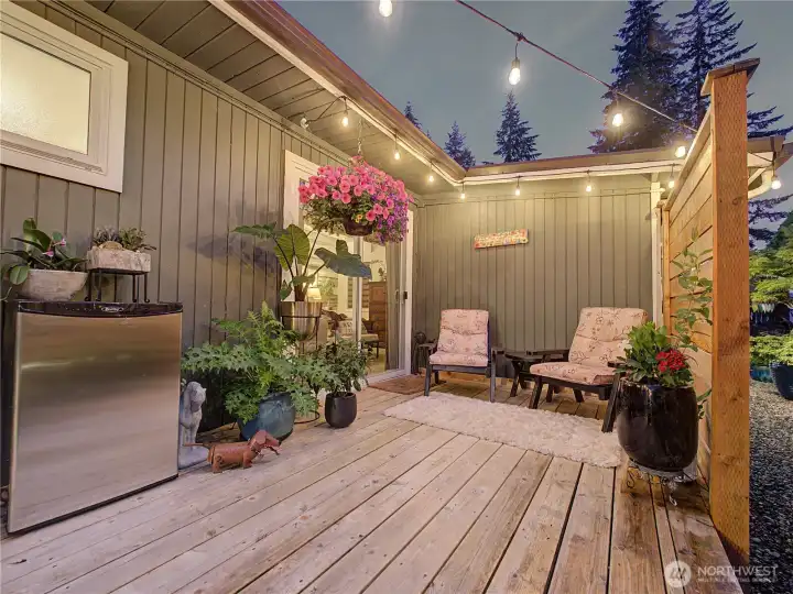 An inviting outdoor oasis designed for relaxation and entertaining. Surrounded by mature landscaping and warm ambient lighting, this peaceful deck extends your living space well beyond the walls of the home.