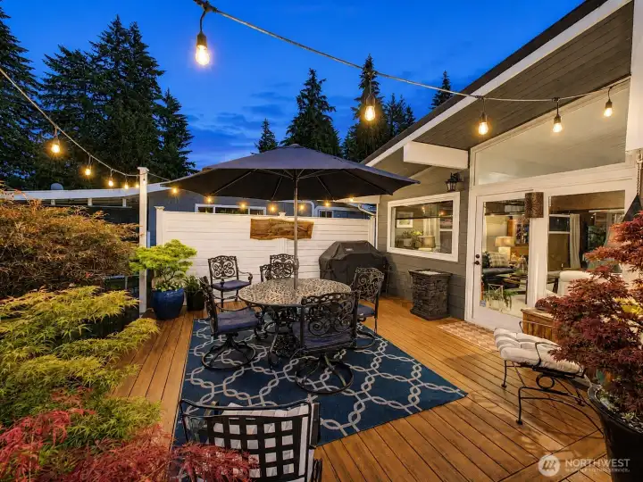 As the sun sets, this private deck transforms into a magical outdoor retreat. Surrounded by lush landscaping and warm ambient lighting, it's the perfect place to enjoy quiet evenings or lively gatherings.