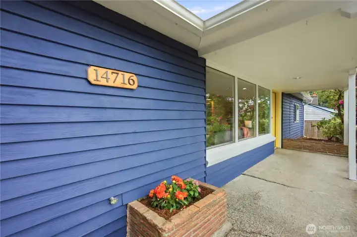 Approaching the front door you'll find a covered front patio with 2 brick planters.