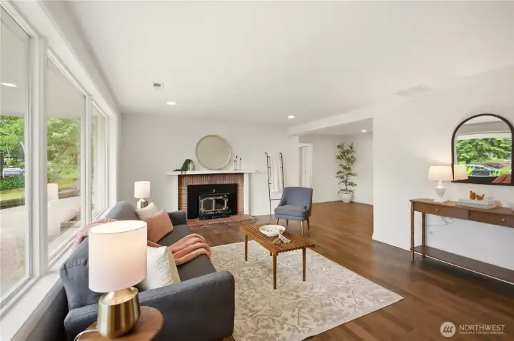 Entering the front door you're in the spacious living room featuring a wall of west facing windows, new engineered hardwood floors and a highly efficient wood burning fireplace insert with fireplace mantel.