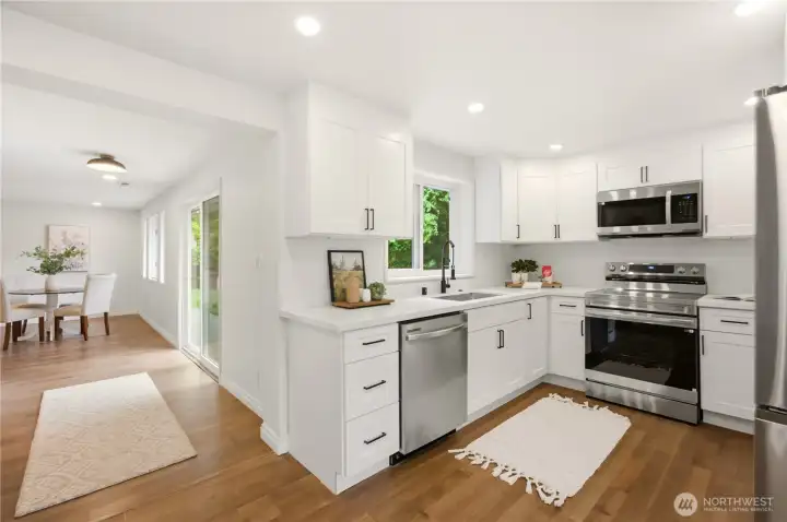 The kitchen has been completely renovated with new cabinets, new sink, new countertops and new stainless steel appliances.
