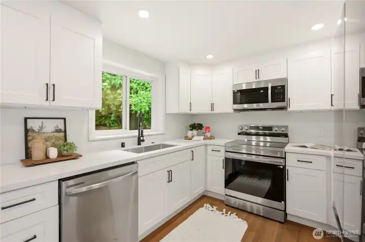 Th is kitchen has never been used! The window above the undermount sink looks out over the spacious back yard and back patio.